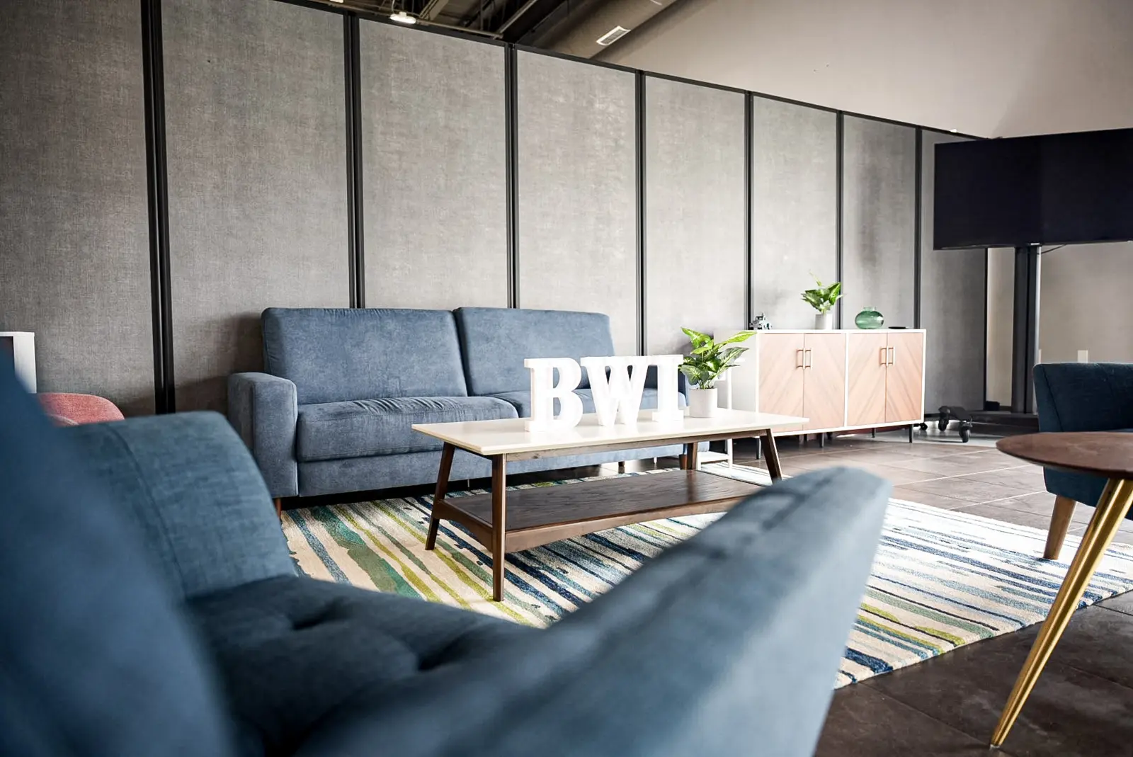 Seating area of the finished lounge, looking across the armchairs to the cabinetry
