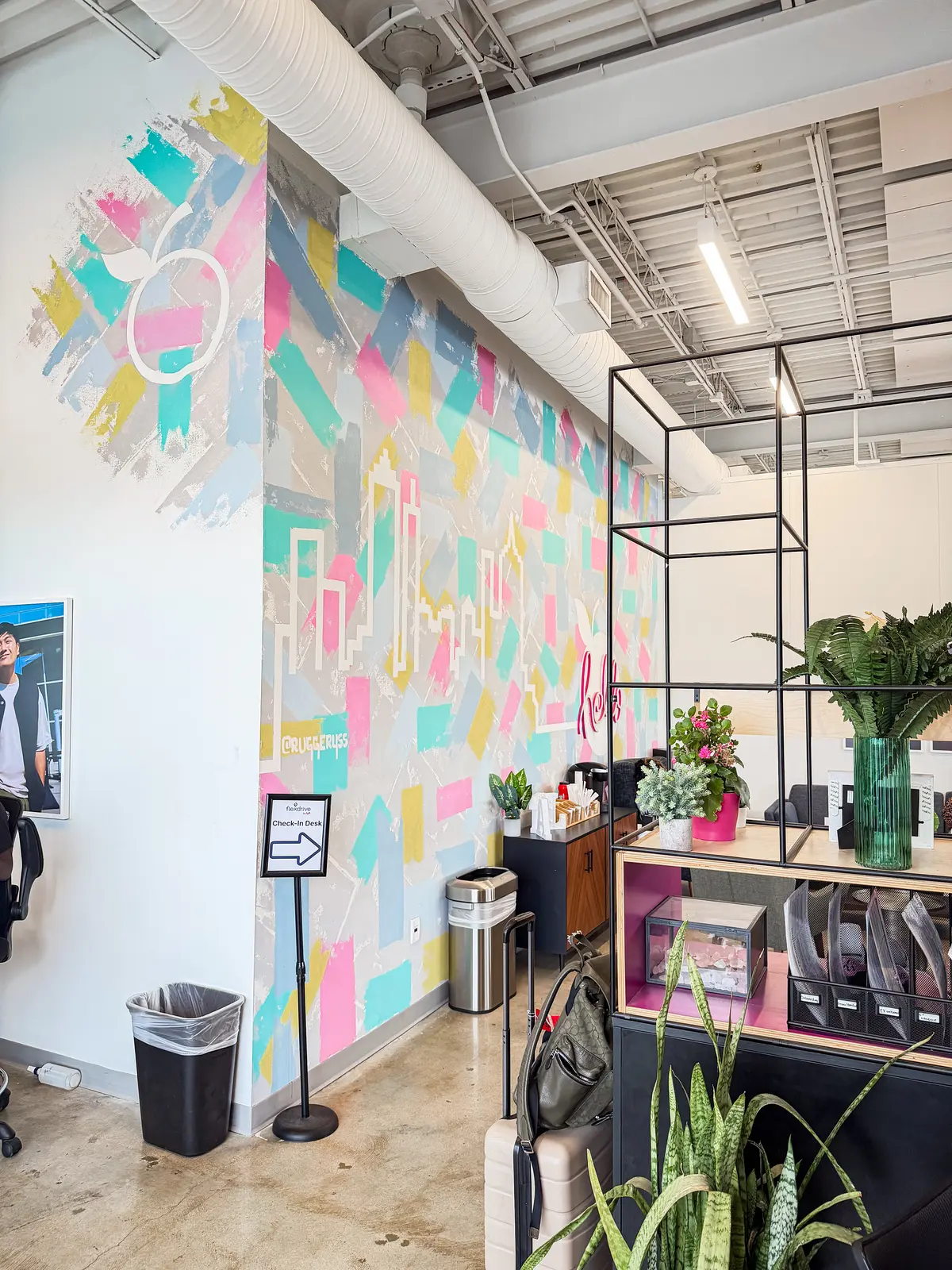 Reception counter and painted mural wall in a completed office fit-out